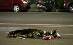 The body of a little girl lies covered in the street in Nice, just one of 84 victims of this senseless barbarianism